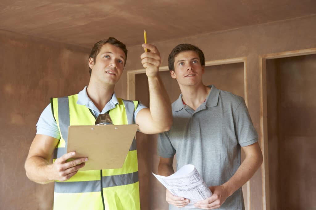 home inspector pointing at ceiling for homeowner