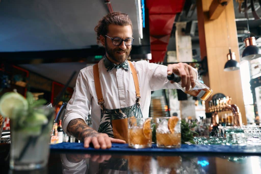 Bartender pouring mixed drinks