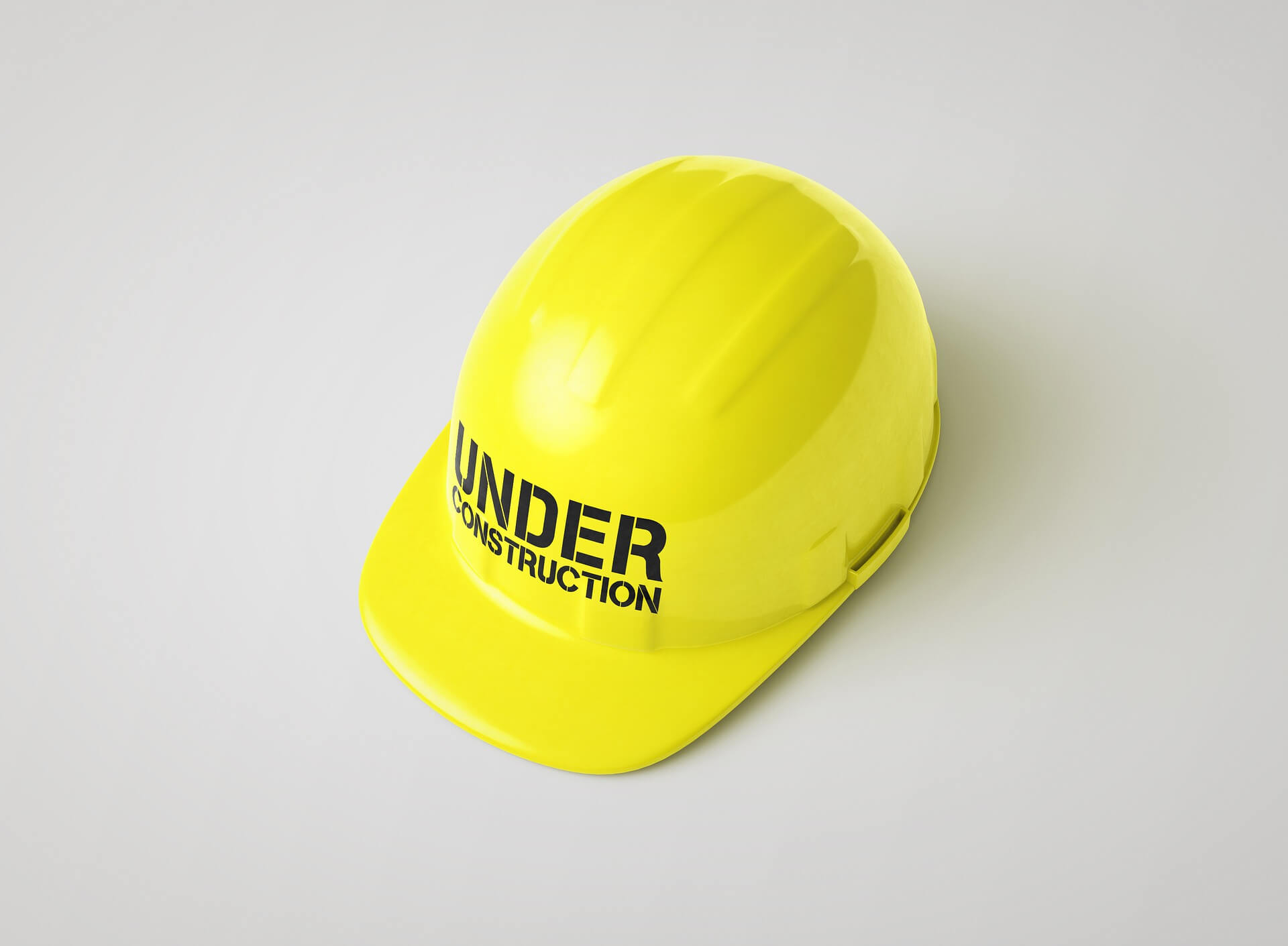 Yellow hard hat reading "under construction"