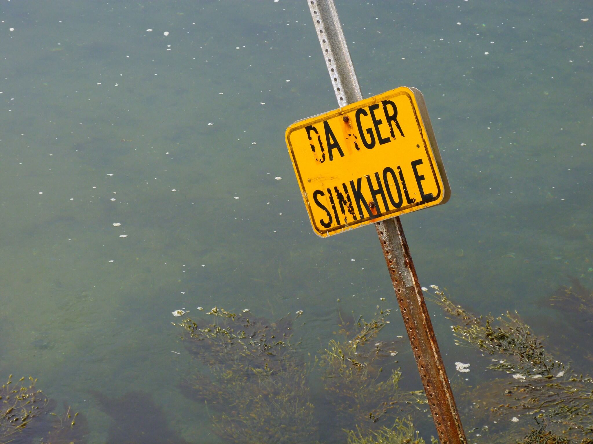 sign reading "Danger Sinkhole"