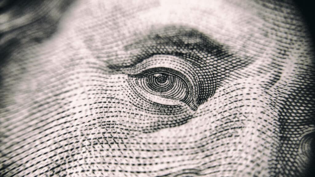 close up of Benjamin Franklin's eye on hundred dollar bill