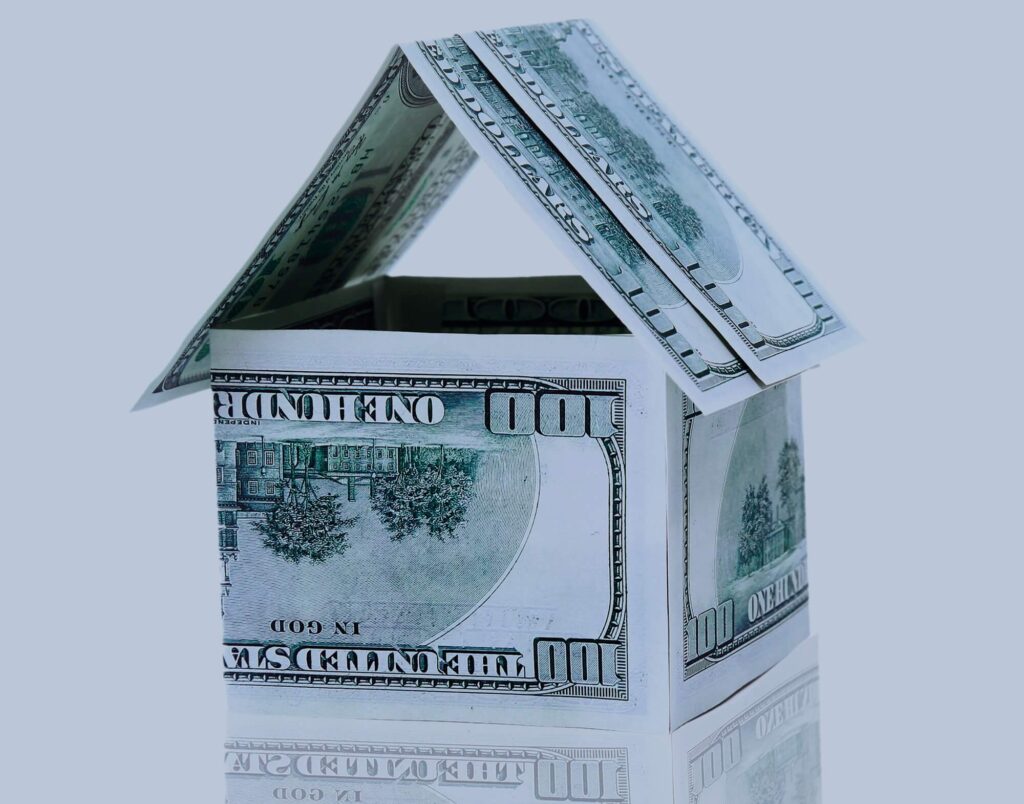 A house made up of folded $100 bills
