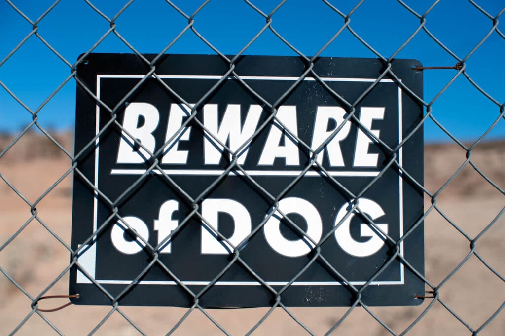 Beware of Dog sign tied to chainlink fence
