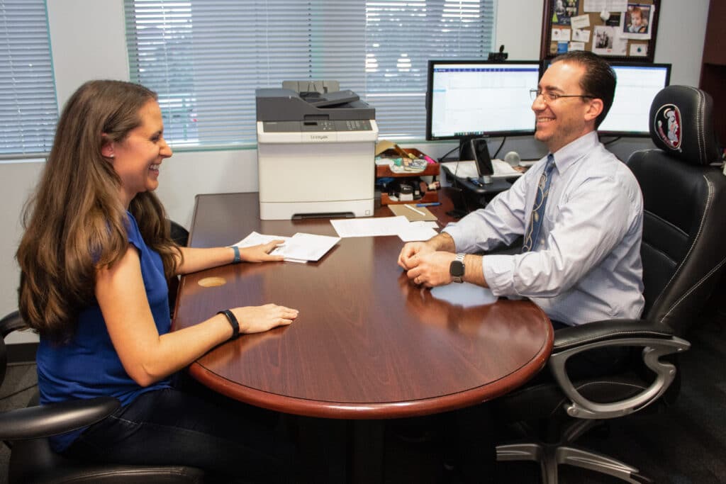 Jason and Julie Levine laughing in their office