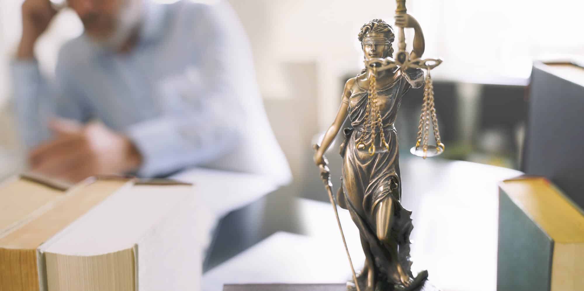 Justice statute on lawyer's desk