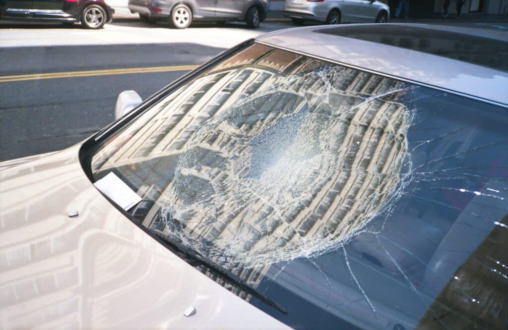closeup of car with smashed windshield