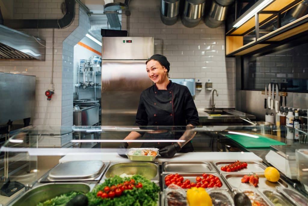 smiling female chef in kitchen