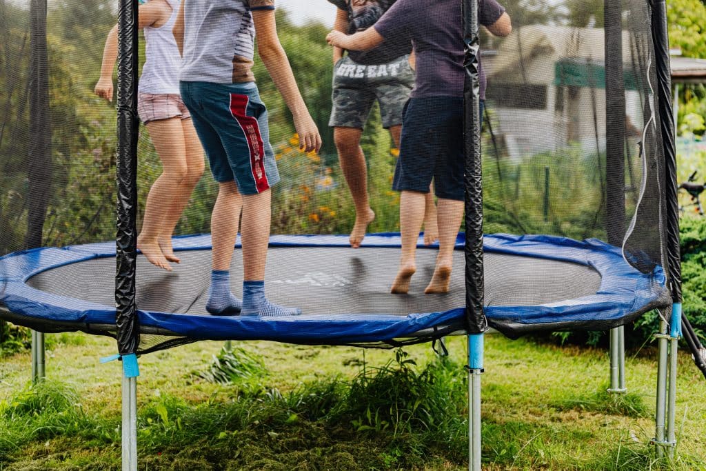 four children jumping on trampoline