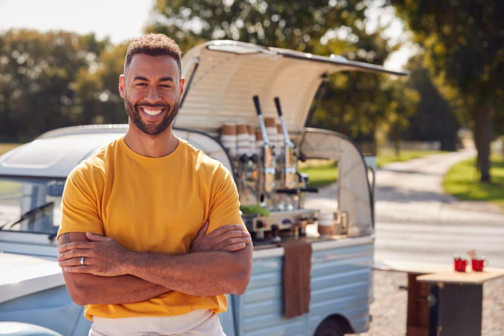 man smiling outside coffee truck